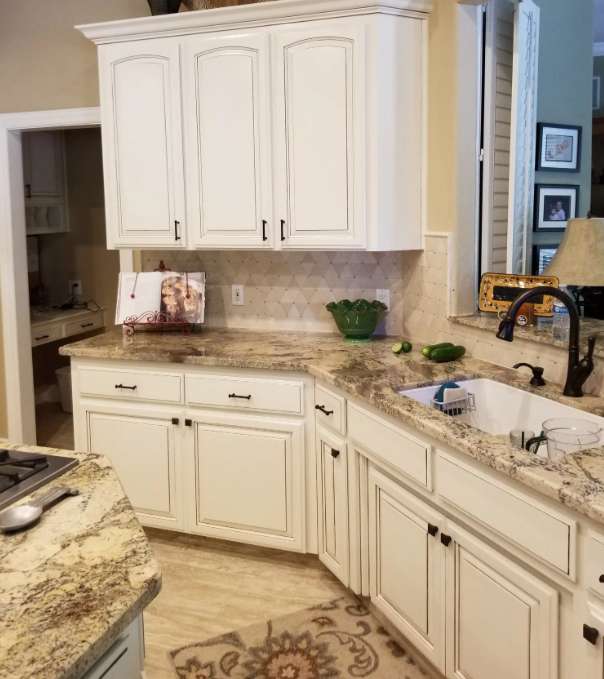 Cream glazed kitchen cabinets with granite counters and diamond tile backsplash in Madera, CA