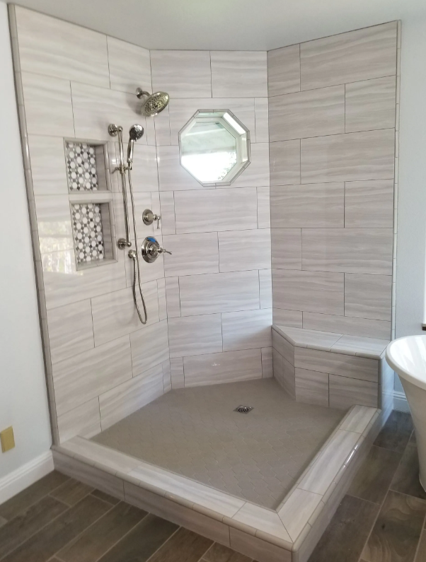 Walk-in tile shower with built-in bench and mosaic niches in a Madera, CA bathroom remodel
